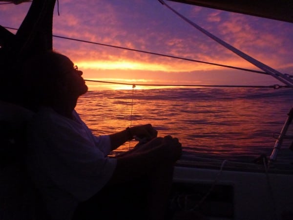 Jim on watch, sunset, Pacific crossing