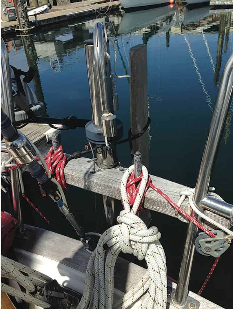 Solo Sailing - Our aft pinrail braces the two sides of the stern pulpit (where a stern ladder was removed) and supports the windvane. Two belaying pins made of bronze rod and wrapped in tarred seine twine keep lines in order.