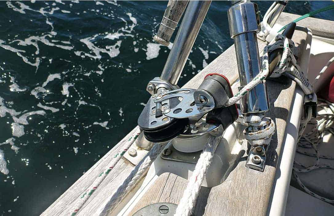 Solo Sailing - The block and cam cleat, located aft next to the cockpit, above left, ensures the genoa furling line (green fleck) has a fair lead with low friction and is fast and easy to pull.