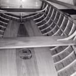 If a round-bottomed boat has floor timbers, a centerline floorboard can rest on them, with the adjoining 'boards secured to the steam-bent hull frames.
